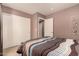 Bright bedroom with a queen bed, sliding door closet and wall decor at 45707 W Barbara Ln, Maricopa, AZ 85139
