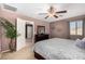 Spacious bedroom with carpeted floors and ceiling fan at 45707 W Barbara Ln, Maricopa, AZ 85139