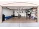 Two-car garage with storage shelving and extra space at 45707 W Barbara Ln, Maricopa, AZ 85139