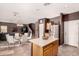 Kitchen with island, stainless steel appliances, and wood cabinets at 45707 W Barbara Ln, Maricopa, AZ 85139