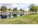 Serene community lake with waterfall feature and lush landscaping at 45707 W Barbara Ln, Maricopa, AZ 85139