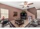 Spacious living room with sectional sofa and large TV at 45707 W Barbara Ln, Maricopa, AZ 85139