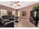Living room with sectional sofa and flat-screen TV at 45707 W Barbara Ln, Maricopa, AZ 85139