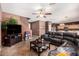 Living room features a large sectional sofa and a ceiling fan at 45707 W Barbara Ln, Maricopa, AZ 85139