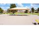 Community playground with swings, shade structure, and playset at 45707 W Barbara Ln, Maricopa, AZ 85139