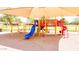 Community playground with slides, swings, and shade structure at 45707 W Barbara Ln, Maricopa, AZ 85139