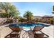 Tranquil pool area with lounge chairs and a small table at 45707 W Barbara Ln, Maricopa, AZ 85139