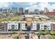 This aerial view shows modern apartment buildings near a green field and downtown buildings at 475 N 9Th St # 115, Phoenix, AZ 85006