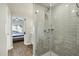 A bright bathroom with glass shower doors, gray subway tile, and wood-look floors at 475 N 9Th St # 115, Phoenix, AZ 85006