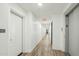 The hallway features wood-look floors, bright white walls, and access to elevators at 475 N 9Th St # 115, Phoenix, AZ 85006
