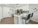 Well-appointed kitchen featuring white cabinetry, stainless steel appliances, and a convenient breakfast bar at 475 N 9Th St # 115, Phoenix, AZ 85006