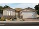 One-story house with a brown roof, light beige walls, and a two-car garage at 4807 N 177Th Ln, Goodyear, AZ 85395