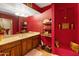 Bathroom with wooden vanity and red walls at 5131 N 18Th St, Phoenix, AZ 85016