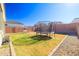Backyard with grass, trampoline, and a swing set at 5323 W Chuck Box Rd, Laveen, AZ 85339