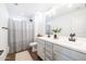 Clean bathroom with double sinks, gray cabinets, and a shower/tub combo at 5323 W Chuck Box Rd, Laveen, AZ 85339