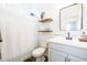 Clean bathroom with white vanity, mirror, and shower at 5323 W Chuck Box Rd, Laveen, AZ 85339