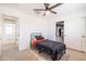 Bright bedroom with a twin bed, closet, and access to a hallway at 5323 W Chuck Box Rd, Laveen, AZ 85339