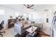 Bright Gathering room with a sectional sofa, ceiling fan, and built-in bookshelves at 5323 W Chuck Box Rd, Laveen, AZ 85339