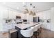 Modern kitchen with island, white cabinets, and stainless steel appliances at 5323 W Chuck Box Rd, Laveen, AZ 85339