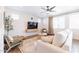Bright living room with sofa, chairs, and a large TV at 5323 W Chuck Box Rd, Laveen, AZ 85339