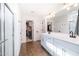 Modern bathroom with dual vanity, large mirror, and a walk-in shower at 5323 W Chuck Box Rd, Laveen, AZ 85339
