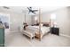Main bedroom with a post bed, carpet flooring, and access to the ensuite bathroom at 5323 W Chuck Box Rd, Laveen, AZ 85339