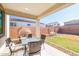 Covered patio with seating area and backyard access at 5323 W Chuck Box Rd, Laveen, AZ 85339