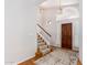 Bright entryway with hardwood floors, staircase, and decorative rug at 5418 E Piping Rock Rd, Scottsdale, AZ 85254