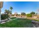 Backyard with a water feature, grassy area, and stone pathways at 6658 S St Andrews Ct, Gilbert, AZ 85298