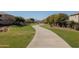 Curving concrete path through a landscaped community at 8912 S 40Th Dr, Laveen, AZ 85339