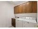 Laundry room with washer, dryer, and cabinets at 8912 S 40Th Dr, Laveen, AZ 85339
