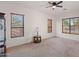 Bright living room with large windows and ceiling fan at 8912 S 40Th Dr, Laveen, AZ 85339