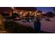 Night view of a backyard pool and patio area with lighting at 8945 N Cordoniz Ln, Casa Grande, AZ 85194