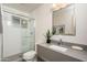 Modern bathroom with a walk-in shower, gray vanity, and updated fixtures at 1009 E Tuckey Ln, Phoenix, AZ 85014