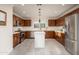 Modern kitchen with dark wood cabinets, stainless steel appliances, and an island at 1009 E Tuckey Ln, Phoenix, AZ 85014