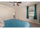 Spacious bedroom with teal bedding and access to a bathroom at 10815 S 175Th Dr, Goodyear, AZ 85338