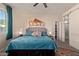 Bright bedroom featuring a gray headboard and teal bedding at 10815 S 175Th Dr, Goodyear, AZ 85338