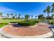Brick path winds through a lush community landscape with palm trees at 10815 S 175Th Dr, Goodyear, AZ 85338