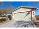 One-story house with a two-car garage and American flag at 10815 S 175Th Dr, Goodyear, AZ 85338