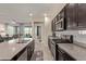 Modern kitchen with dark cabinets, granite counters and island at 10815 S 175Th Dr, Goodyear, AZ 85338