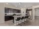 Modern kitchen with dark cabinetry, granite counters, and island at 10815 S 175Th Dr, Goodyear, AZ 85338