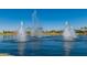 Serene lake with multiple water fountains and palm trees at 10815 S 175Th Dr, Goodyear, AZ 85338