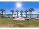 Scenic lakefront view with fountains, palm trees, and a park bench at 10815 S 175Th Dr, Goodyear, AZ 85338