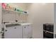 Laundry room with washer, dryer, and extra shelving at 10815 S 175Th Dr, Goodyear, AZ 85338