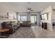 Bright living room with gray sectional sofa and access to backyard at 10815 S 175Th Dr, Goodyear, AZ 85338