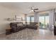 Cozy living room featuring a gray sectional and backyard access at 10815 S 175Th Dr, Goodyear, AZ 85338