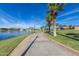 Brick walkway along lake with palm trees and streetlight at 10815 S 175Th Dr, Goodyear, AZ 85338