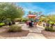 Inviting backyard with a sparkling pool, patio furniture, and built-in BBQ at 1103 E Kael Cir, Mesa, AZ 85203