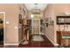 Light and spacious entryway with wood flooring and decorative accents at 1103 E Kael Cir, Mesa, AZ 85203