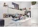 Functional kitchen with white cabinets, a marble countertop island, and an array of appliances at 11606 W Laurelwood Ln, Avondale, AZ 85392